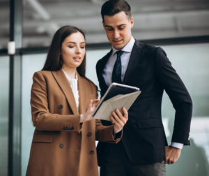 Male And Female Business People Working On Tablet In Office E1622148367576 Min